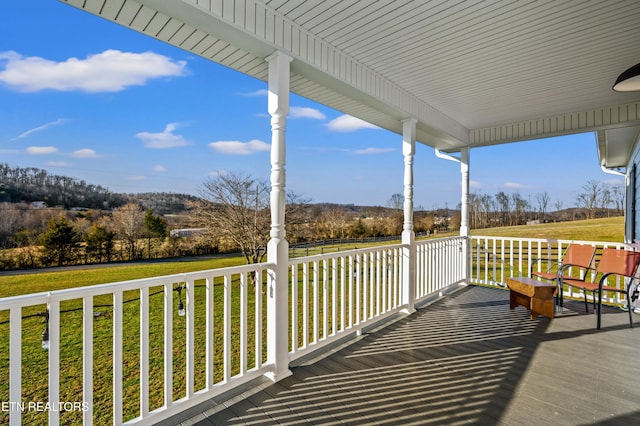 wooden terrace with a yard