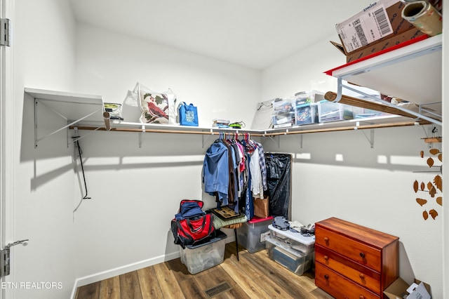 walk in closet featuring wood finished floors and visible vents