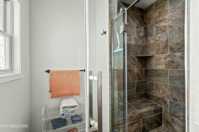 bathroom featuring a shower stall