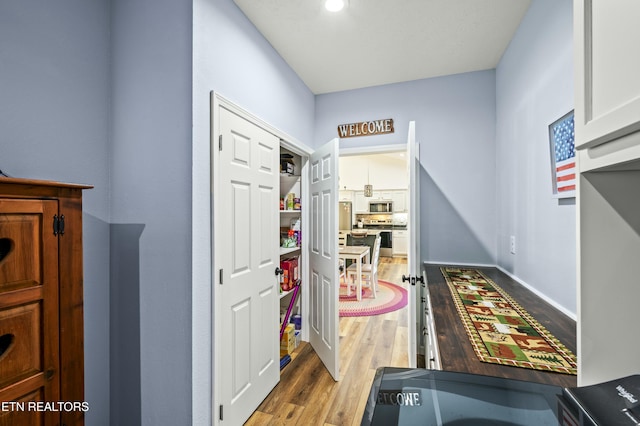 interior space featuring baseboards and wood finished floors