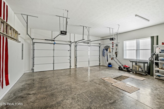 garage with a garage door opener and baseboards