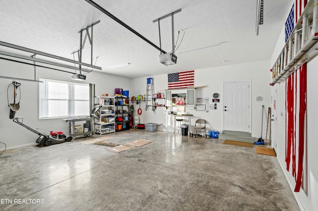 garage featuring a garage door opener and baseboards