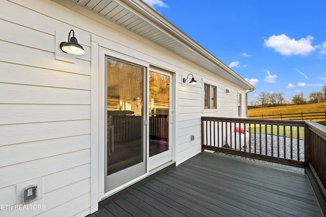 wooden terrace featuring fence