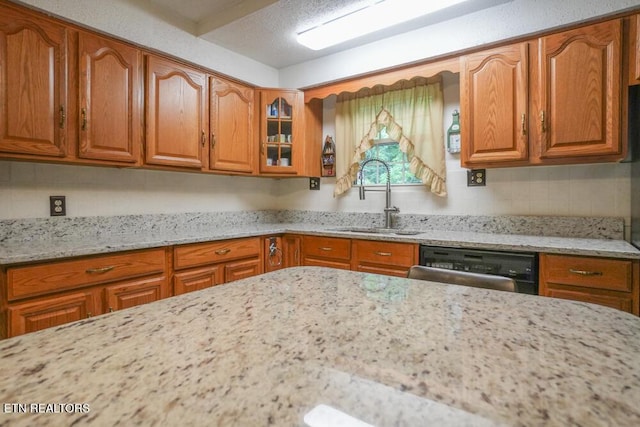 1301 Chert Pit Rd, Knoxville, TN 37923 - kitchen featuring dishwasher, light stone countertops, and brown cabinetry