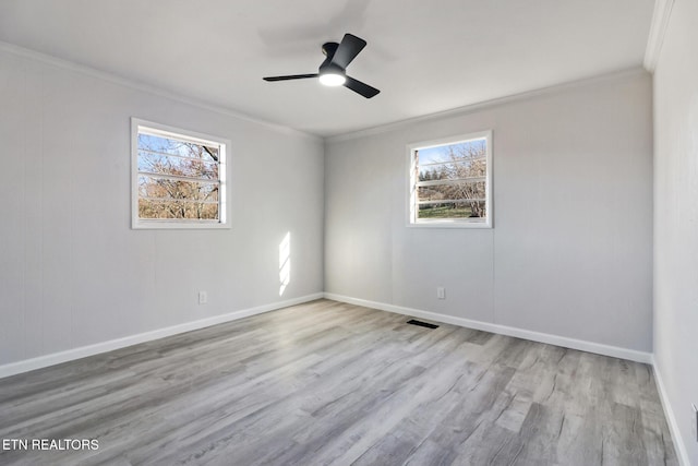 spare room featuring ceiling fan, wood finished floors, baseboards, and ornamental molding