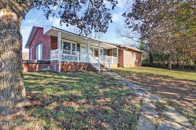 ranch-style house with a porch, brick siding, and a front yard