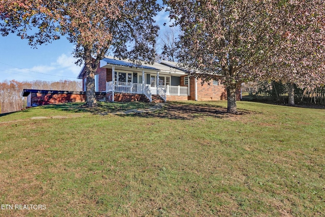 view of front facade featuring a porch, a front yard, and metal roof