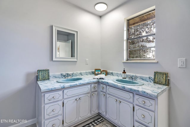 bathroom featuring double vanity and a sink