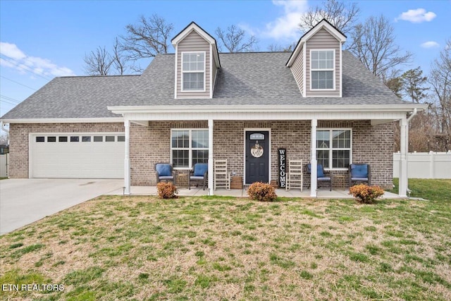 new england style home featuring a garage, brick siding, concrete driveway, and a front yard