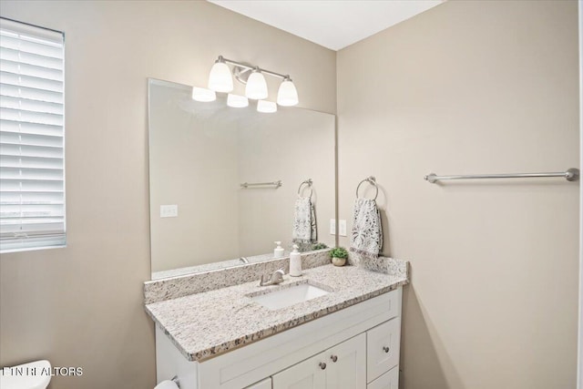 half bathroom featuring toilet and vanity