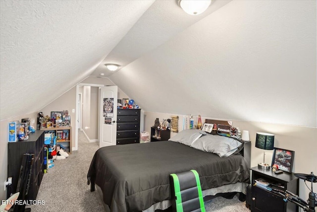 bedroom featuring vaulted ceiling, carpet floors, and a textured ceiling