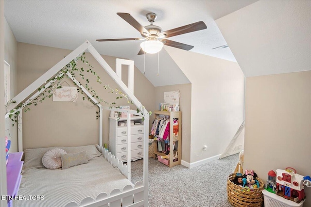 carpeted bedroom with vaulted ceiling, baseboards, and ceiling fan