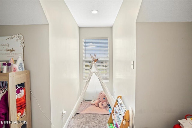 rec room with baseboards and carpet floors