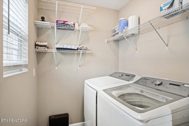 washroom featuring laundry area and washing machine and dryer