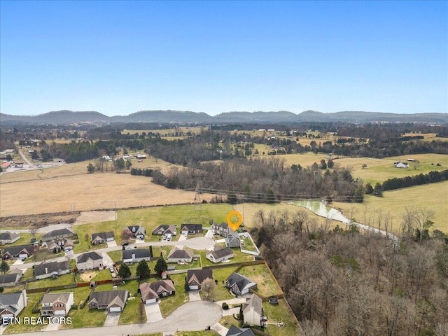 drone / aerial view featuring a rural view and a mountain view