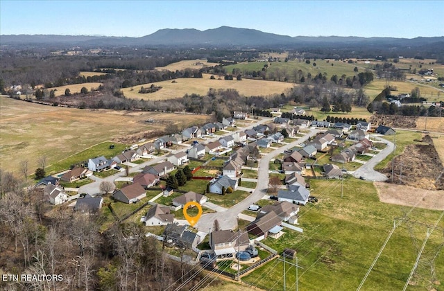 birds eye view of property featuring a residential view, a rural view, and a mountain view