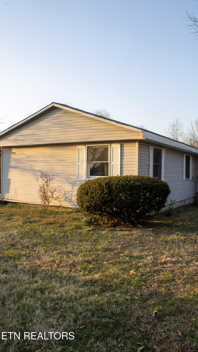 view of home's exterior featuring a yard