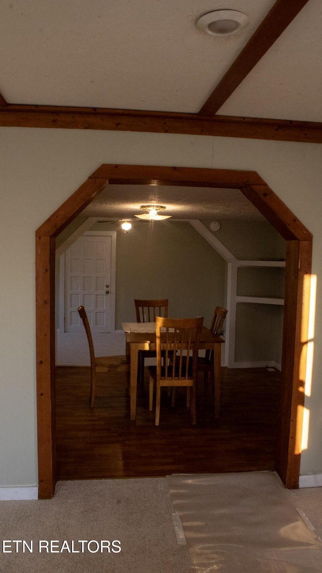 unfurnished dining area with lofted ceiling and wood finished floors