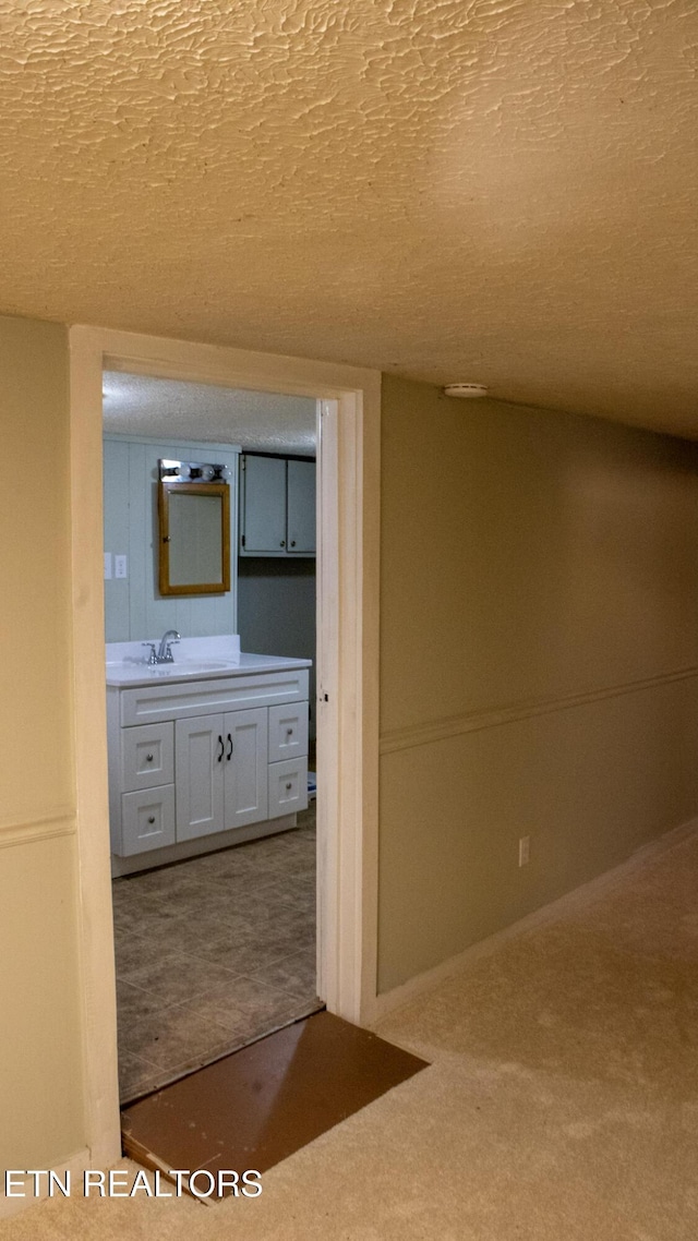 bathroom featuring a textured ceiling and vanity