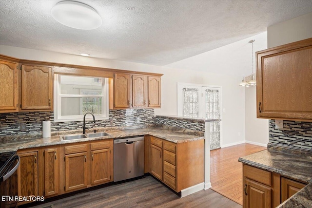 kitchen featuring dark wood finished floors, a peninsula, a sink, black range with electric cooktop, and stainless steel dishwasher