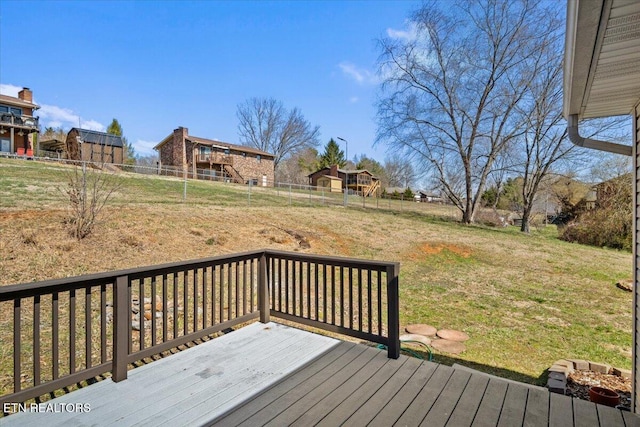 deck featuring fence and a lawn