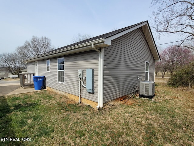 view of home's exterior featuring cooling unit and a yard