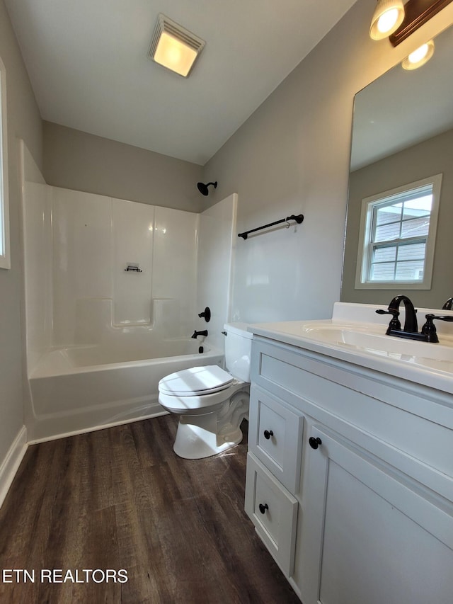 full bathroom with toilet, vanity, bathtub / shower combination, and wood finished floors