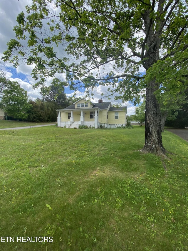 exterior space featuring a front yard and a chimney