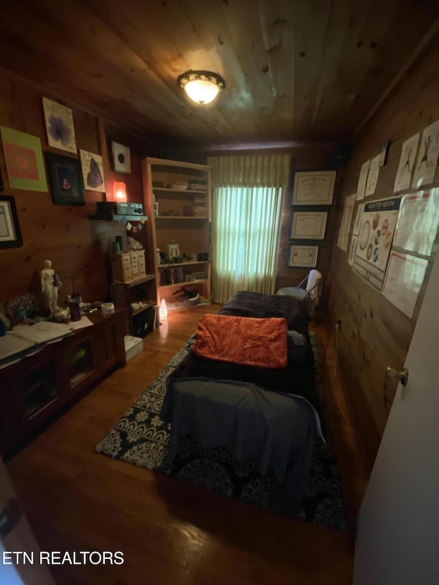 sitting room with wood finished floors, wooden walls, and wood ceiling