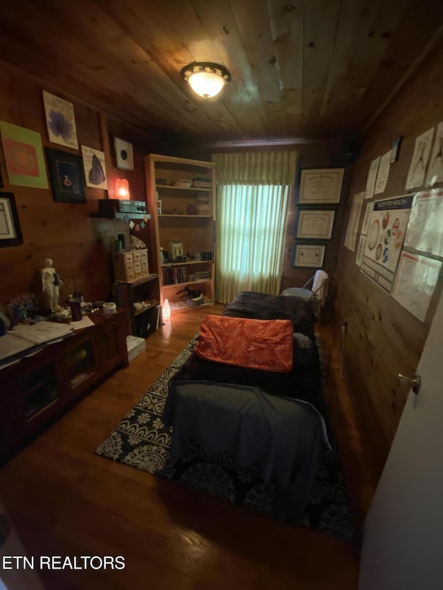 sitting room featuring wood walls, wooden ceiling, and wood finished floors