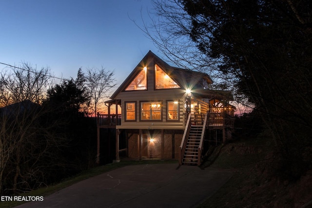 back of property with stairs and a deck