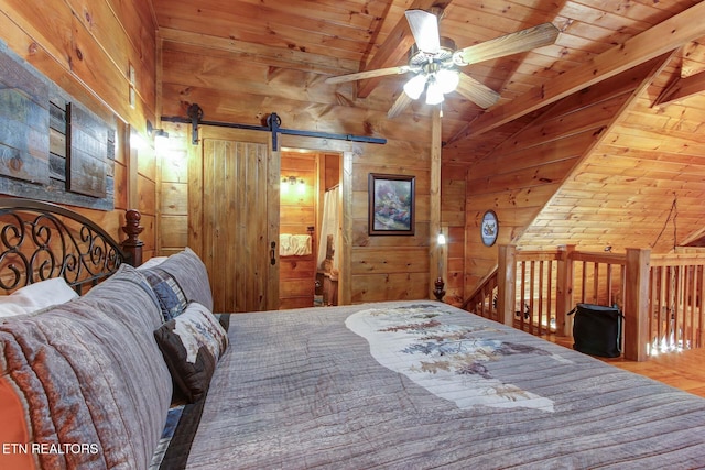 bedroom with vaulted ceiling with beams, wood walls, wood ceiling, and a barn door