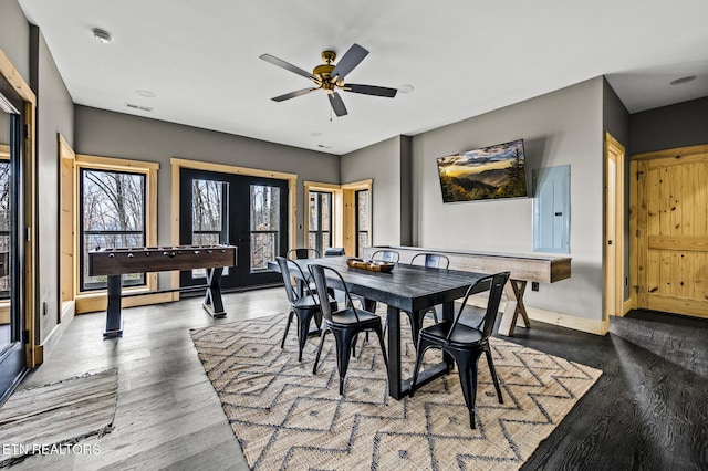 dining space featuring visible vents, baseboards, french doors, wood finished floors, and a ceiling fan