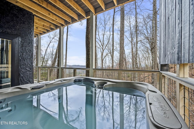 view of swimming pool featuring a hot tub