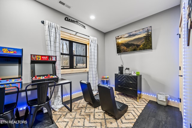 playroom with visible vents, baseboards, and wood finished floors