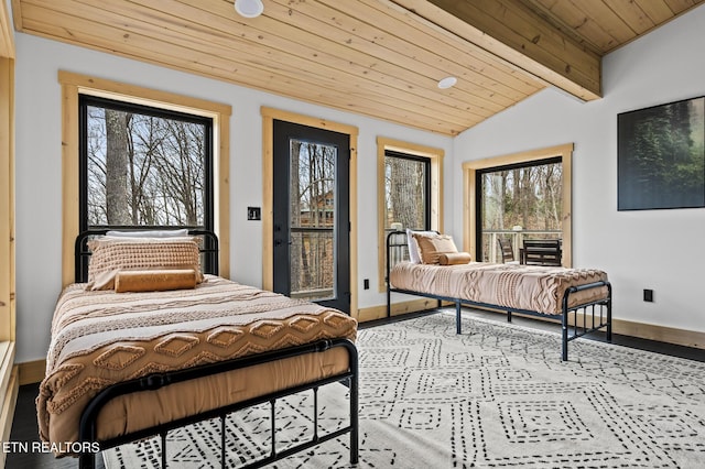 bedroom featuring lofted ceiling with beams, baseboards, multiple windows, and wood ceiling