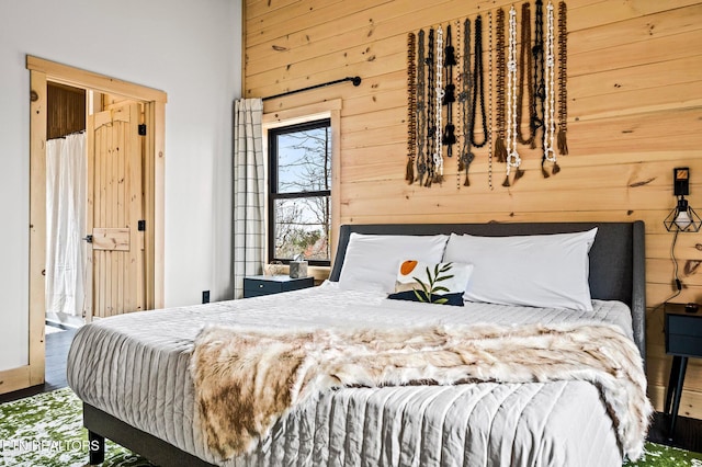 bedroom featuring wooden walls