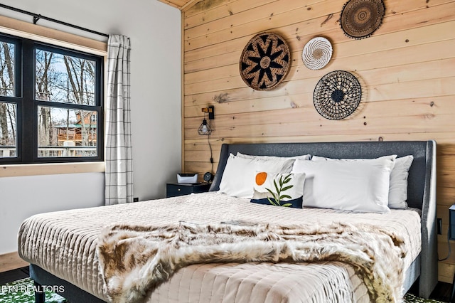 bedroom with wooden walls