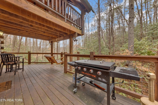 wooden deck with a forest view