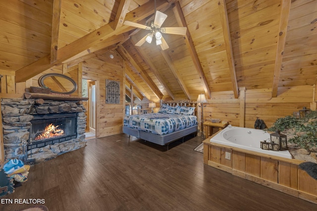 bedroom featuring lofted ceiling with beams, wood finished floors, wood walls, and wooden ceiling