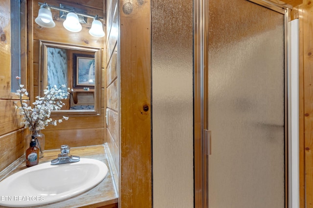 bathroom with a stall shower and vanity