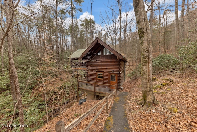 view of outdoor structure featuring aphalt driveway and a forest view