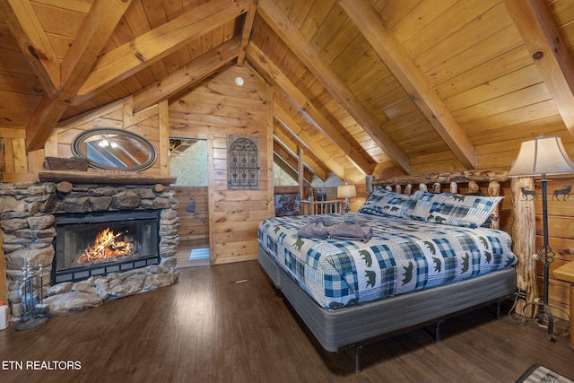 bedroom featuring wooden walls, wood finished floors, lofted ceiling with beams, a stone fireplace, and wood ceiling