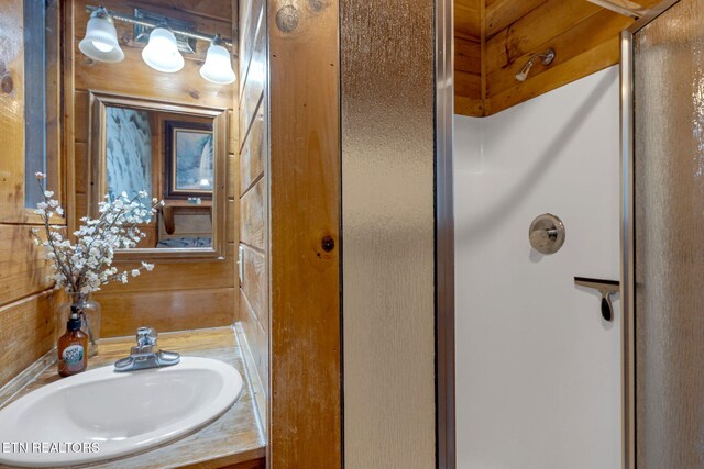 full bath with vanity and a shower stall