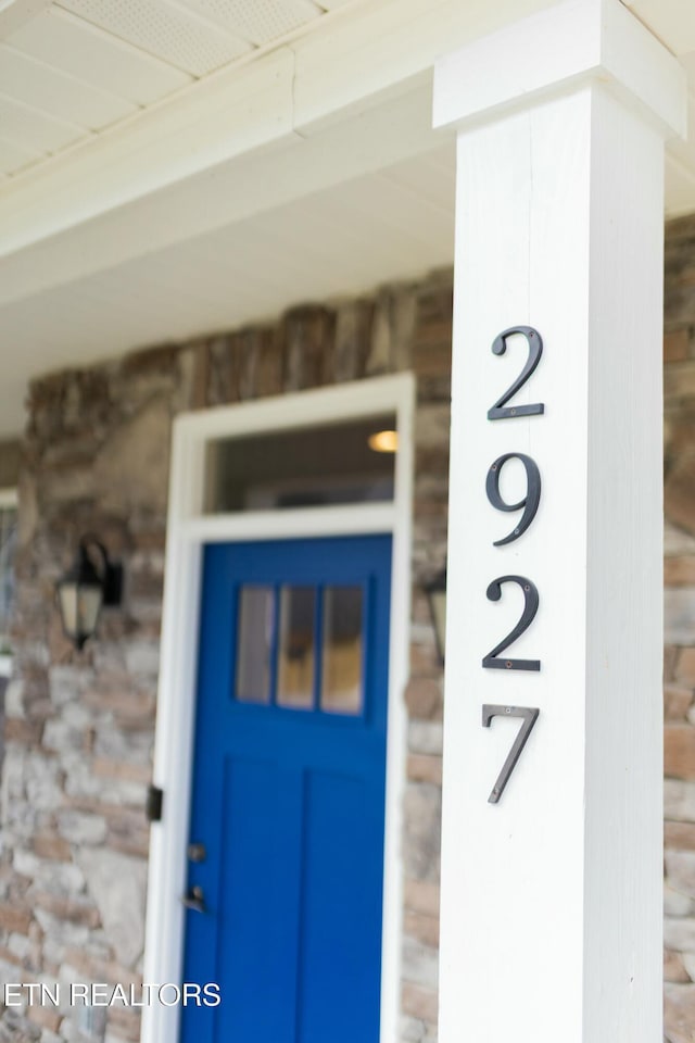 entrance to property featuring stone siding