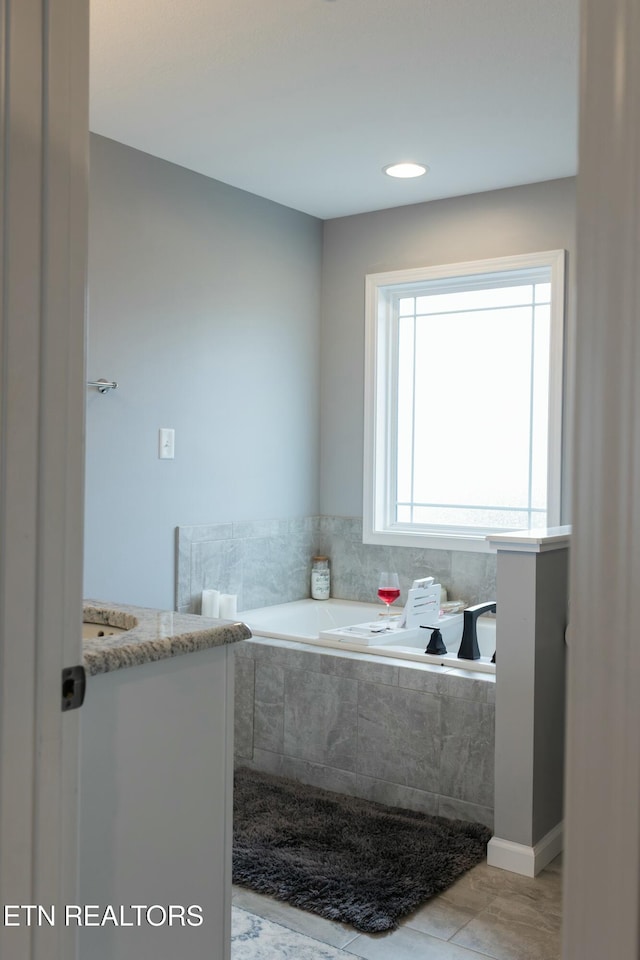 full bathroom featuring tile patterned flooring and a garden tub