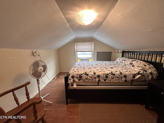 bedroom with baseboards, a textured ceiling, and lofted ceiling