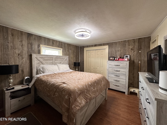 bedroom featuring a closet, a textured ceiling, and dark wood finished floors