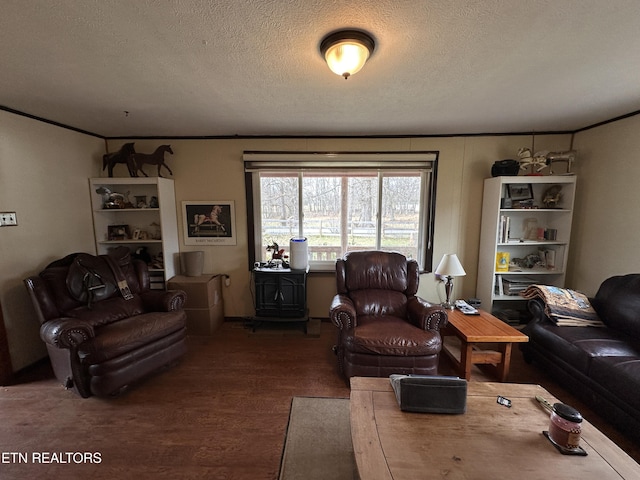 living room with a textured ceiling, wood finished floors, and crown molding