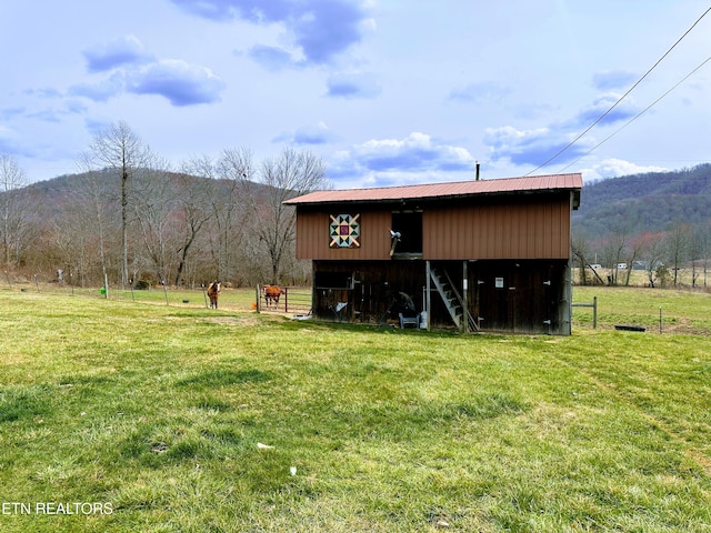 view of outdoor structure featuring a rural view, a mountain view, and an outdoor structure